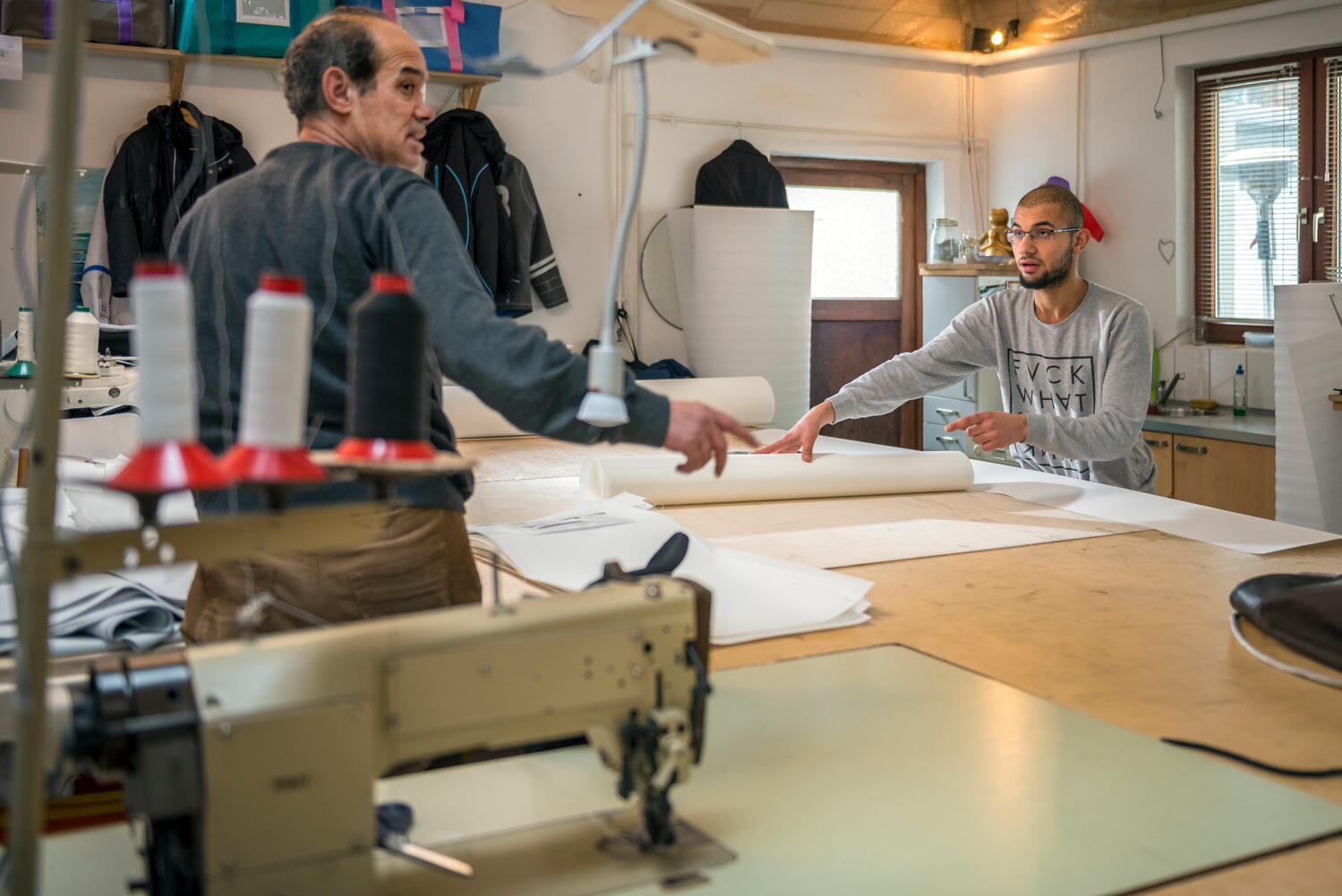Germany. Syrian father and son use sewing skills to start new lives