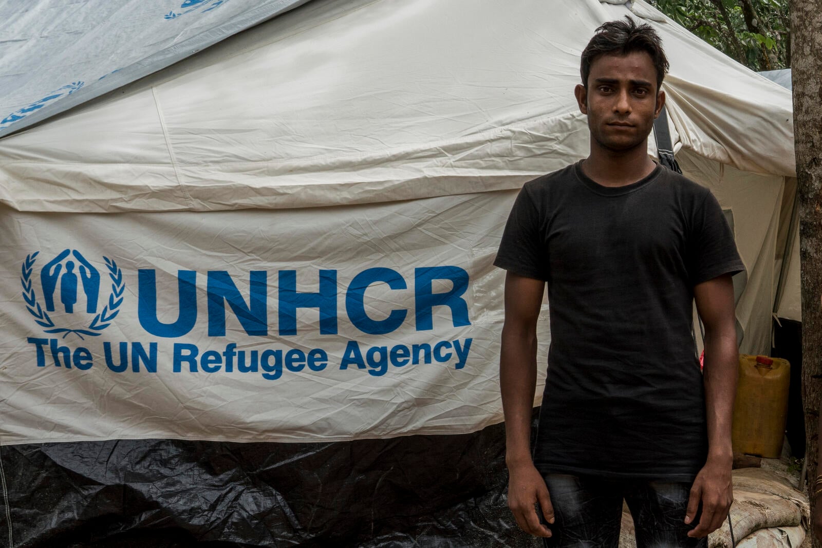 Mohammad Rafique, 20, a Rohingya refugee who fled Myanmar 40 days ago stands outside his tent in the UNHCR Transit Camp near Kutupalong refugee camp in Bangladesh on June 29th, 2018.