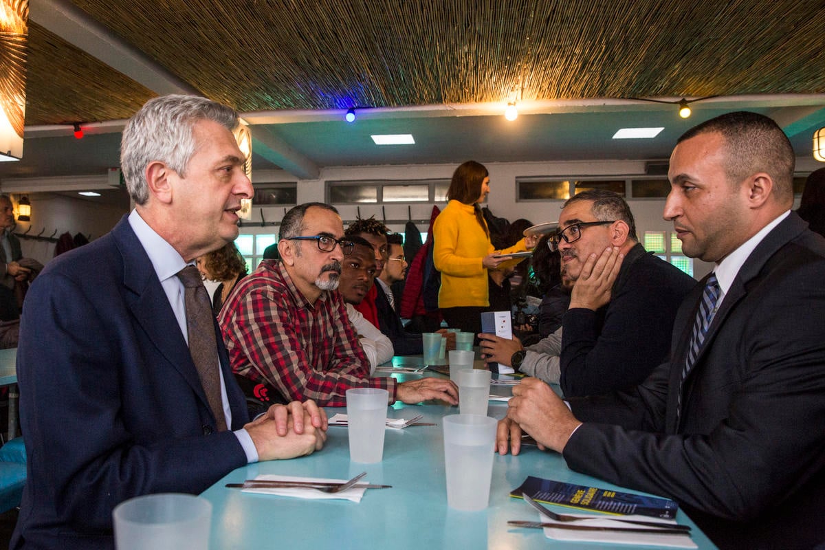 Switzerland. Geneva's lakefront restaurant lays on lunch for a group of refugees
