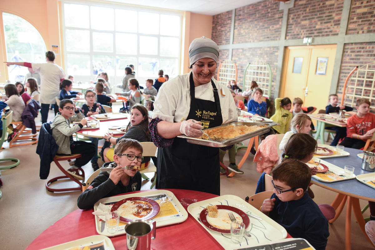 France. Schoolchildren bond with refugee chefs and rappers