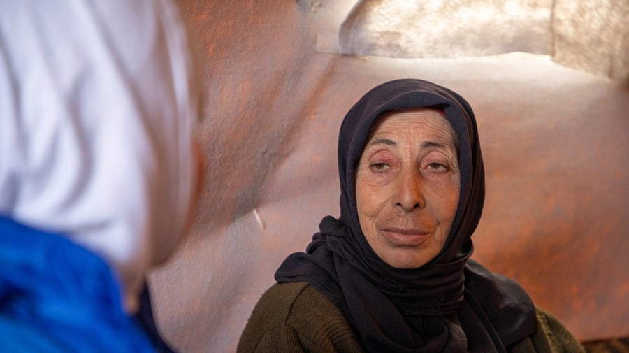  Sana Khaled, 55, talks to a UNHCR staff member inside her family’s tent in an informal camp in rural Idleb, north-west Syria. 