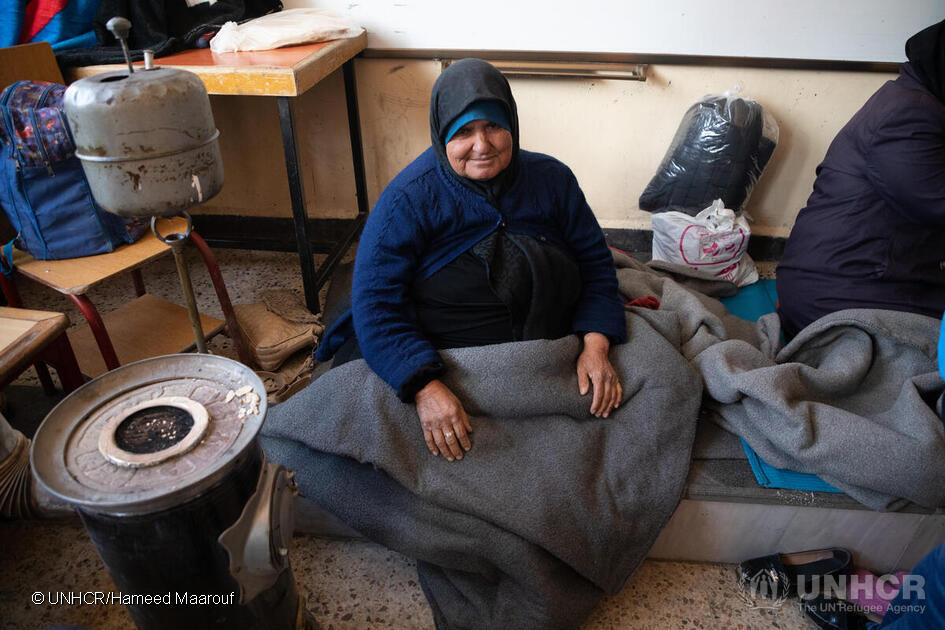 An elderly woman sits in the classroom of a school that has been turned into a collective shelter in the Salahadin neighbourhood of Aleppo, Syria. © UNHCR/Hameed Maarouf