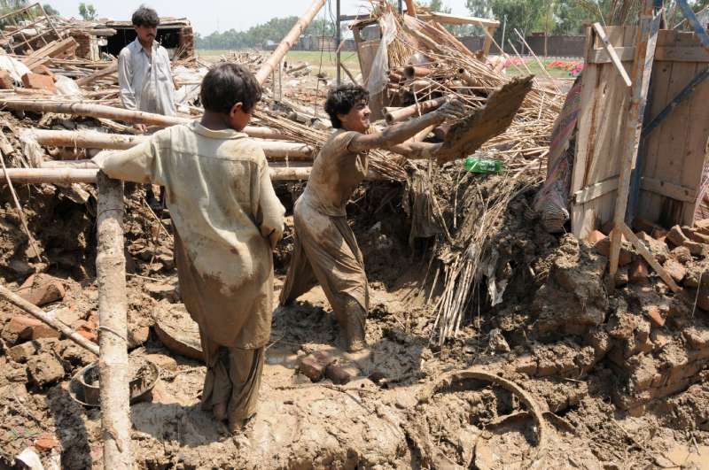 Men digging up the remains of their home in the Azakhel refugee camp near Peshawar, following the floods that have left so much of Pakistan in misery. (Photo: W. Schellenberg, UNHCR)