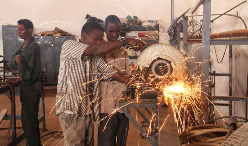 Two students work on a project at the centre's carpentry training programme. Forty boys from different IDP settlements in Galkayo have graduated this year. 