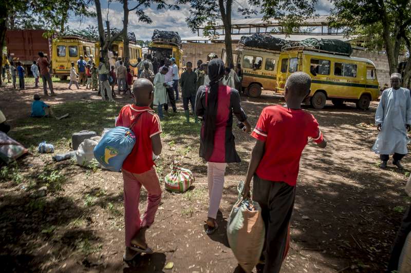 Moussa and Ibrahim, with their 20-year-old sister, Mairama, head towards parked minibuses with their meagre belongings. One of the buses, organized by UNHCR, will take them from Gbiti to Mbile Refugee Camp, where their mother and seven other siblings are waiting for them