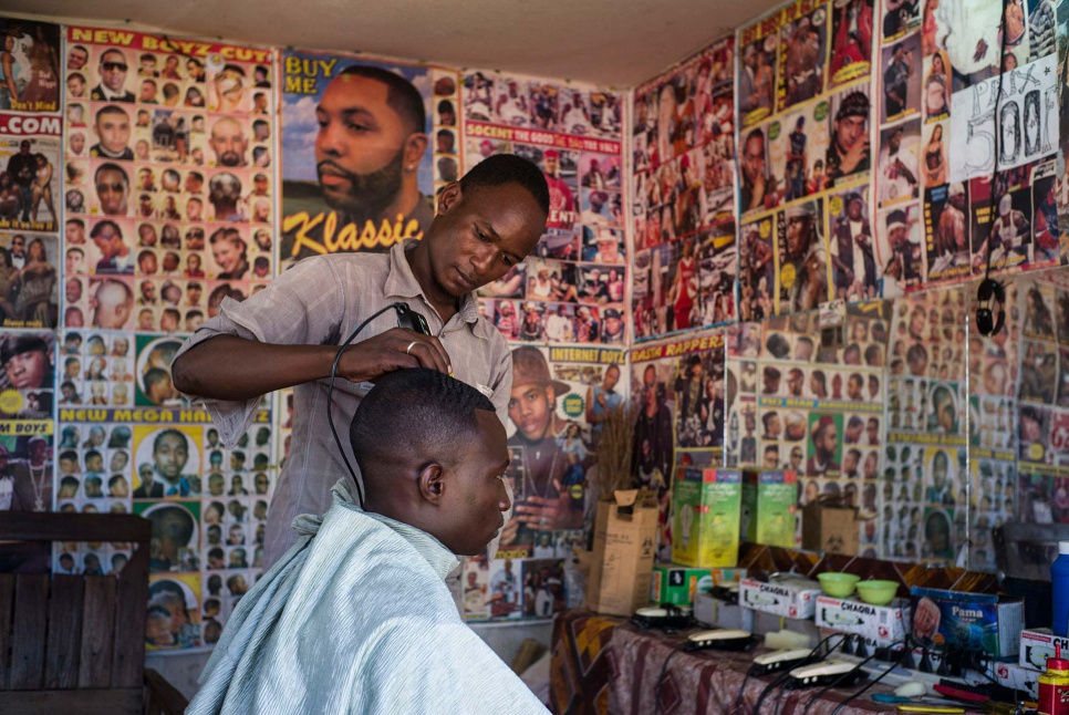 Youssouf, 21, earns money as a hairdresser at Amboko refugee camp in southern Chad.