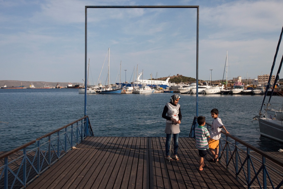 Jihan, Mohammad and Ahmed stand near the harbour in Lavrio, Greece. The water reminds Jihan of the monumental risk they took to reach safety in Europe.