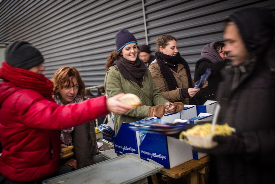 Volunteers from Salaam distribute food to refugees and migrants one evening in Calais' city centre.