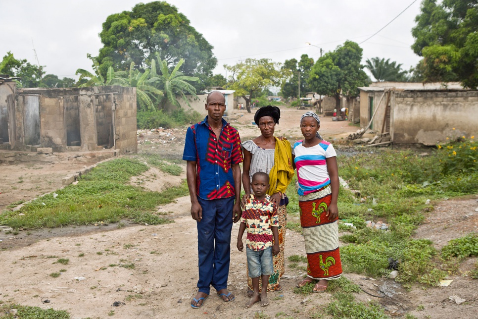 Rakiata stands with her son Adama, 32, daughter Lisette, 20, and grandson Salam, six, near their home in the village of Zuenoula, in central Côte d'Ivoire.