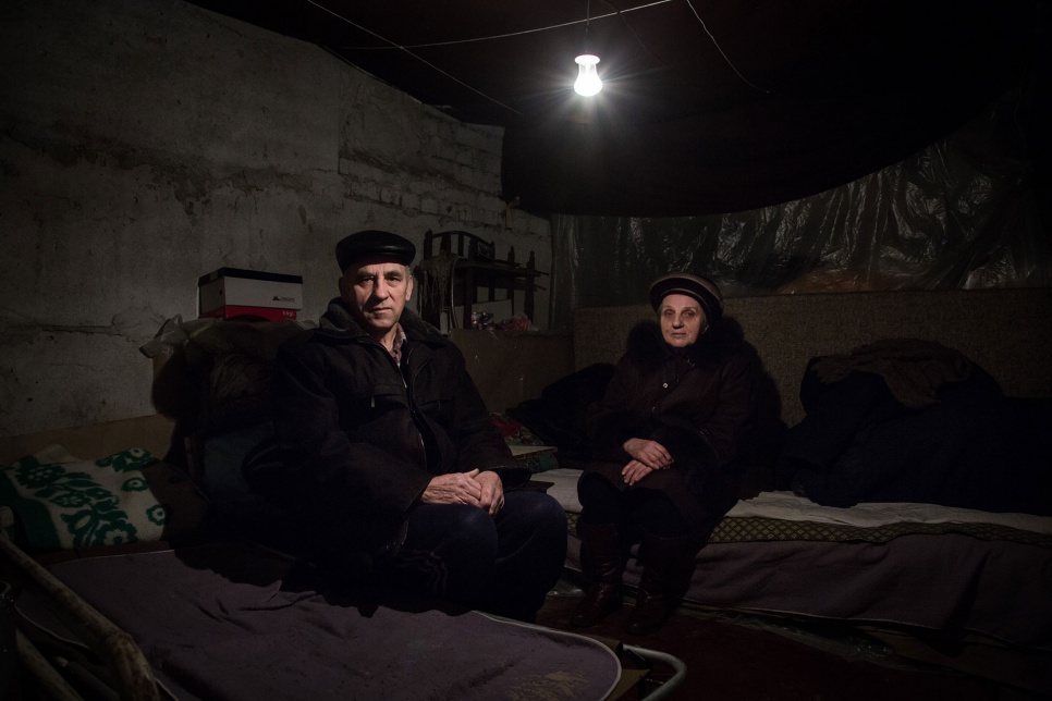 Aleksey and Anna Rudik, both 68, have been staying in their basement to escape nearby fighting. "When they shell, the building shakes," Anna says. "And we shake."