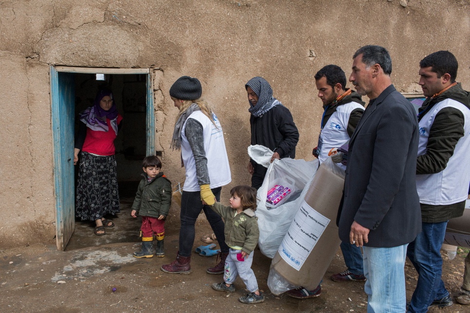 Aid workers from UNHCR and its partner ASAM bring supplies for Mohammed's family, who fled the fighting in Kobane, Syria.