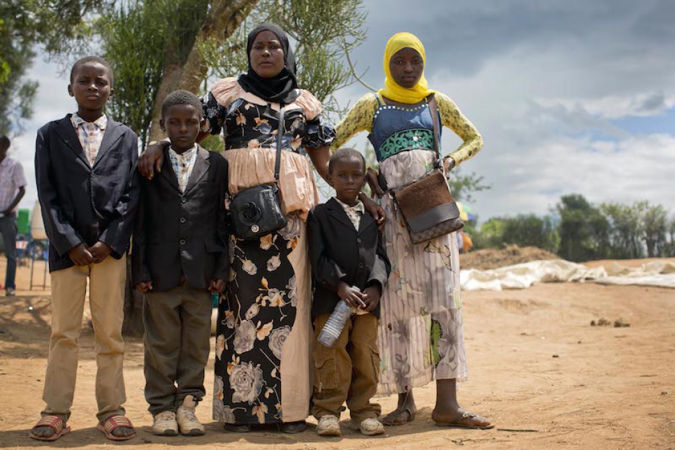 Mwamini stands with four of her children at Rwanda's Mahama refugee camp.