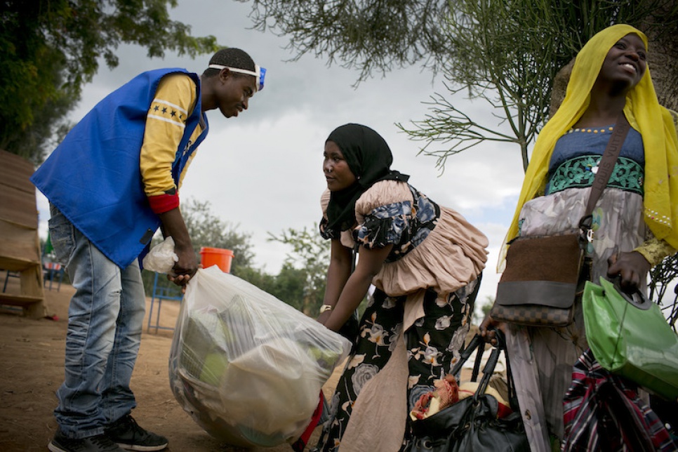 Mwamini collects her belongings before moving into a tent with her children at Mahama refugee camp in Rwanda.