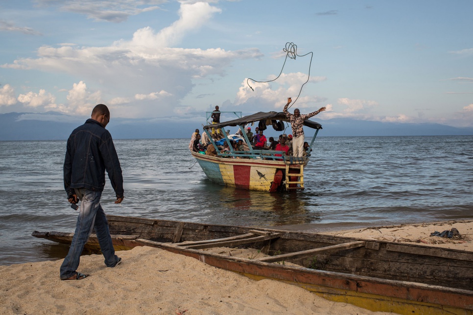 A boat carrying Burundian refugees approaches the western shore of Lake Tanganyika, near Mboko fishing village in the South Kivu province of the Democratic Republic of the Congo.