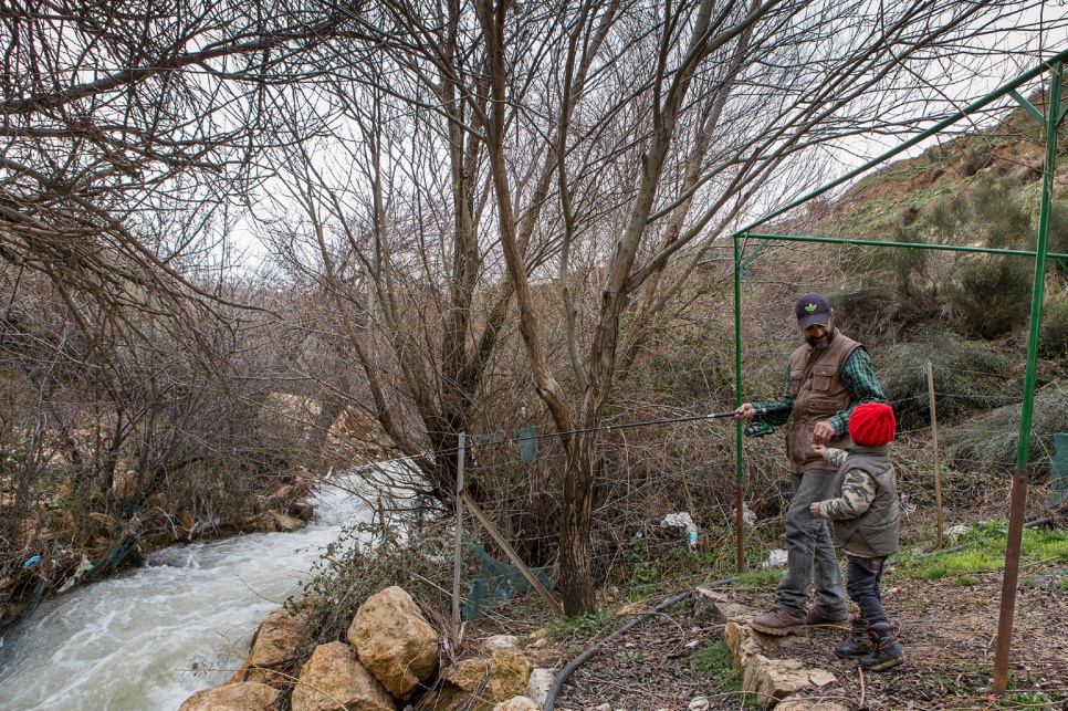 Hassan takes his four-year-old son, Jaafar, trout fishing in Lebanon's Bekaa Valley. What was once a hobby in Syria has become a lifeline in exile.