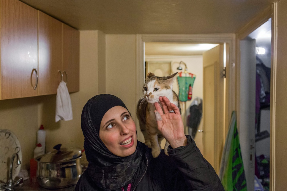 As they crossed the border into Lebanon, Heba hid the family's cat, Boussy, in her purse. Boussy loves to stand on Heba's shoulder, like a parrot.