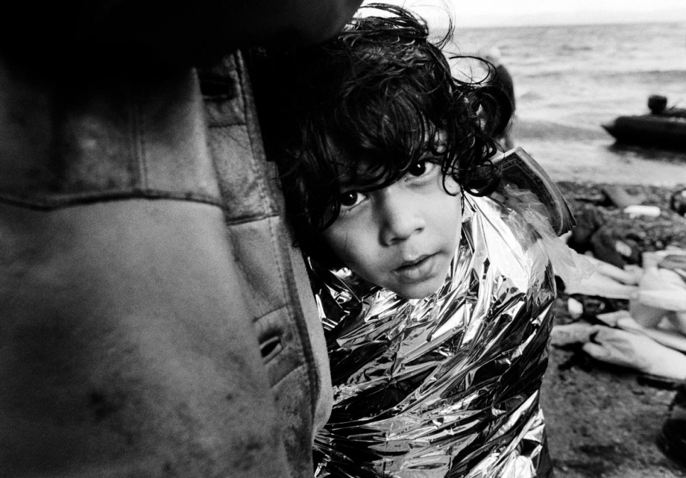A boy from Afghanistan tries to keep warm after landing. As winter sets in, cases of hypothermia are increasing.