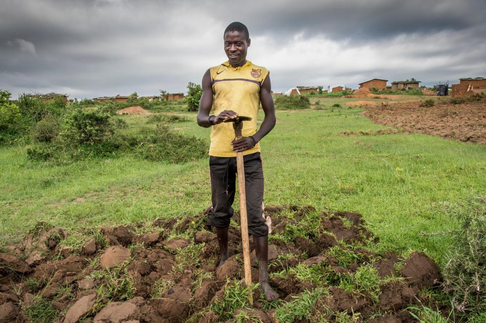 Hatuga, 25, farms his plot of land nearby his house on the edge of Kashojwa.