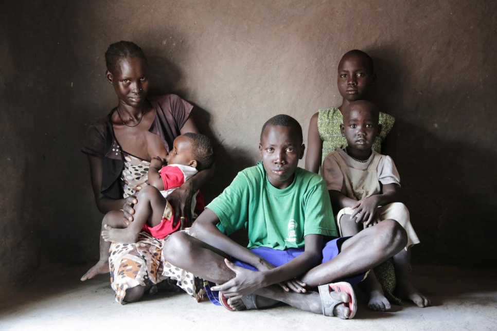 Adut Akol, 27, breastfeeds her youngest boy alongside the rest of her children in Rumbek. They escaped from Mayendit in September 2015, fleeing fighting and hunger.