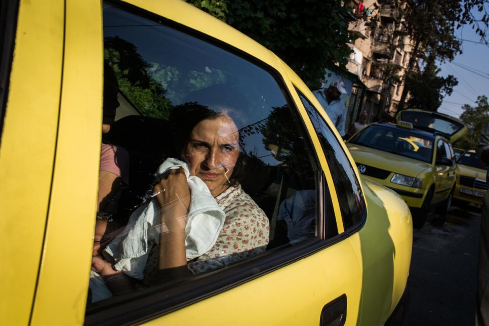 Naleen sits in a taxi outside Gevgelija train station, in Macedonia.