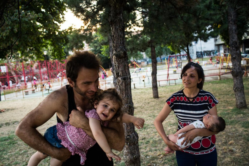 Dara, 29, and Naleen, 24 take a break with their children at a park in Belgrade, Serbia.