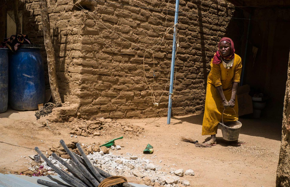 Aza, 45, does construction work in Iriba. It's the only way she can earn enough money to feed her family.