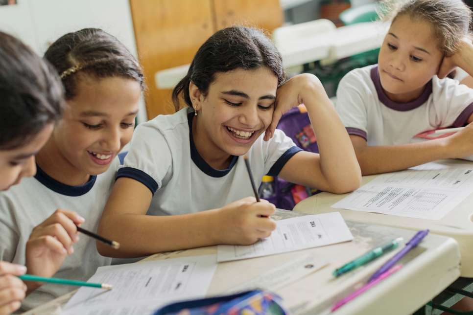 Hanan Dacka (centre), 12, studies alongside her new Brazilian friends Maria and Julia Vanderlei at their school in downtown São Paulo.