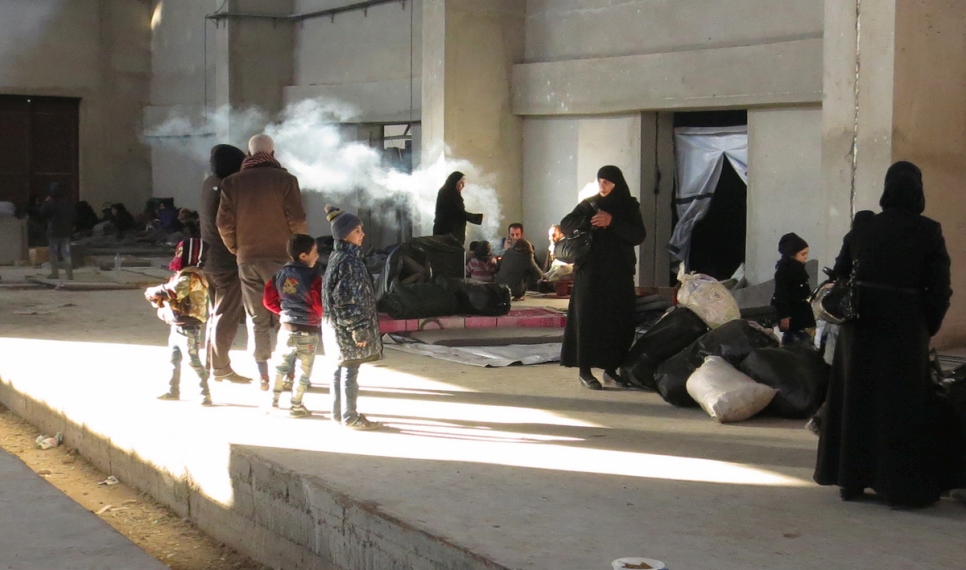 Newly displaced families from east Aleppo reach a shelter in Mahalej, Syria.