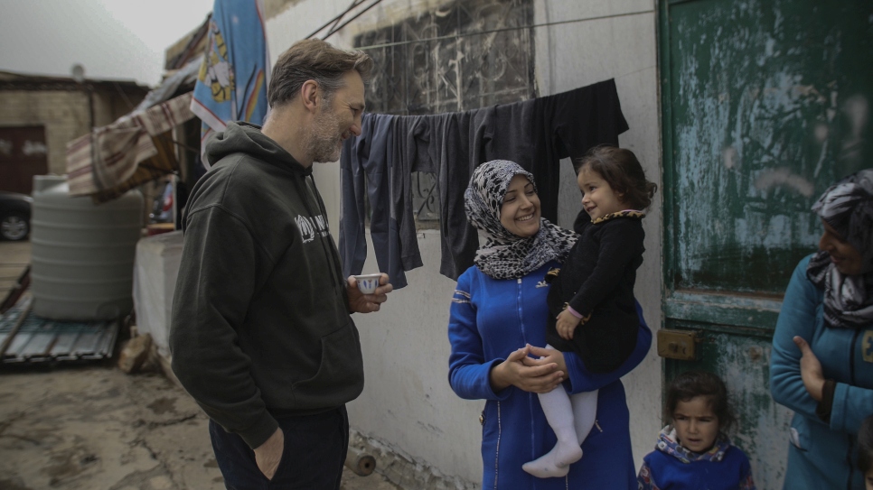 David stands with Hiba and her daughters Lamis (aged 5) and Aseel (aged 2.5) outside their makeshift dwelling in the Bekaa Valley in Lebanon.