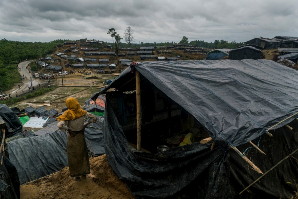 لاجئة من الروهينغا تنظر من مأواها في مخيم عشوائي في ثانكالي، بنغلاديش.