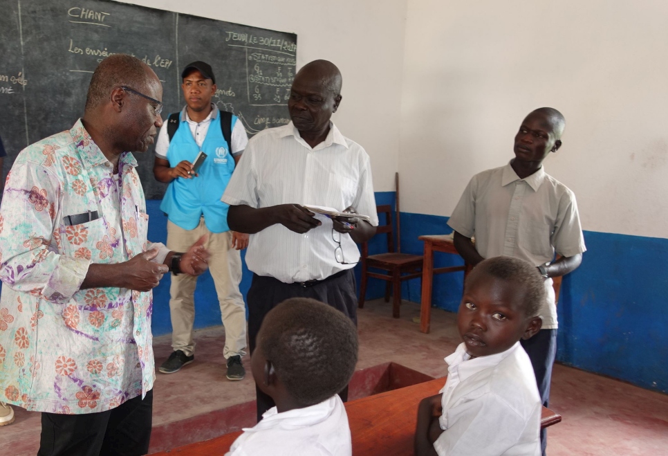 Noah* shares his shelter concerns with Mr. Akodjenou during his visit to Meri refugee site.