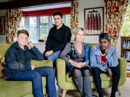 United Kingdom. Ingrid Van Loo Plowman and her youngest son Ross, host three refugees in their home in Epsom, near London: Isak, 18, from Ethiopia, 19-year-old Abdul, from Syria and a 31-year-old engineer from the Middle East who declined to be identified for security reasons. This portrait is part
