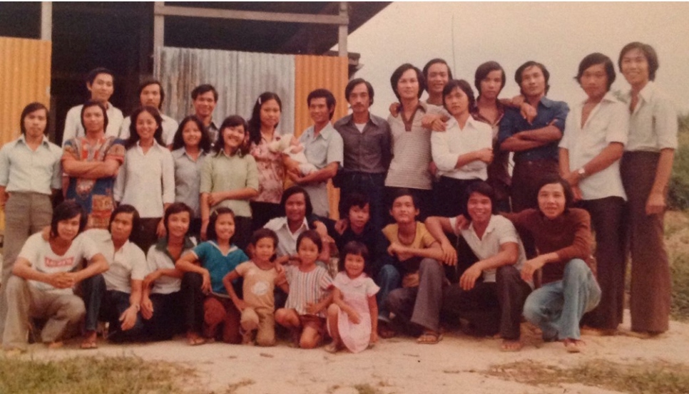 Outdoor group photo of some 30 refugees who fled Viet Nam in 1979 on the same boat as Jennifer Xu's aunt.