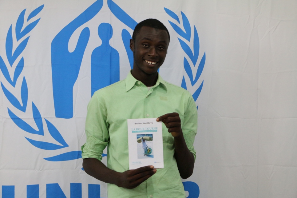 Ibrahim Kanoute poses with his book "La Roue Tourne" at the UNHCR office in Bamako, Mali.