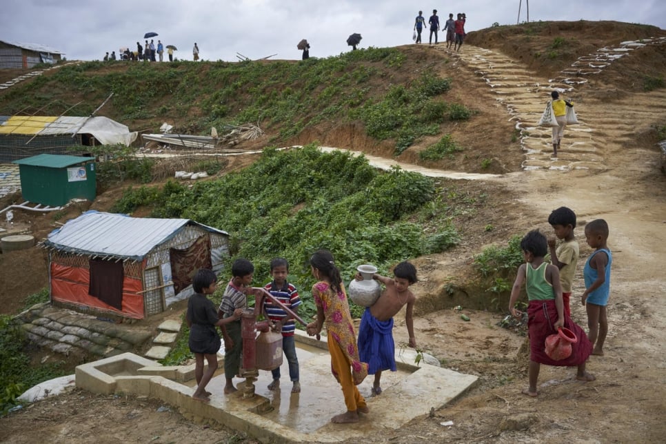 Bangladesh. Rohingya refugees fill containers at a water well in Kutupalong settlement