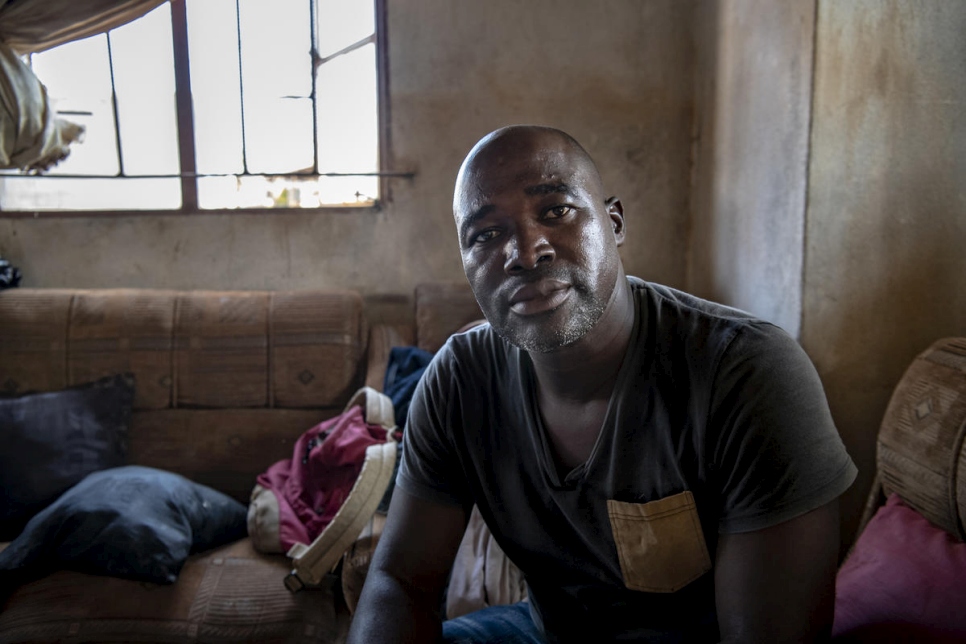 أنطونيو ، 44 عامًا ، يجلس في غرفة المعيشة بمنزله في بوزي، التي لحقت بها أضرار جراء إعصار إيداي.