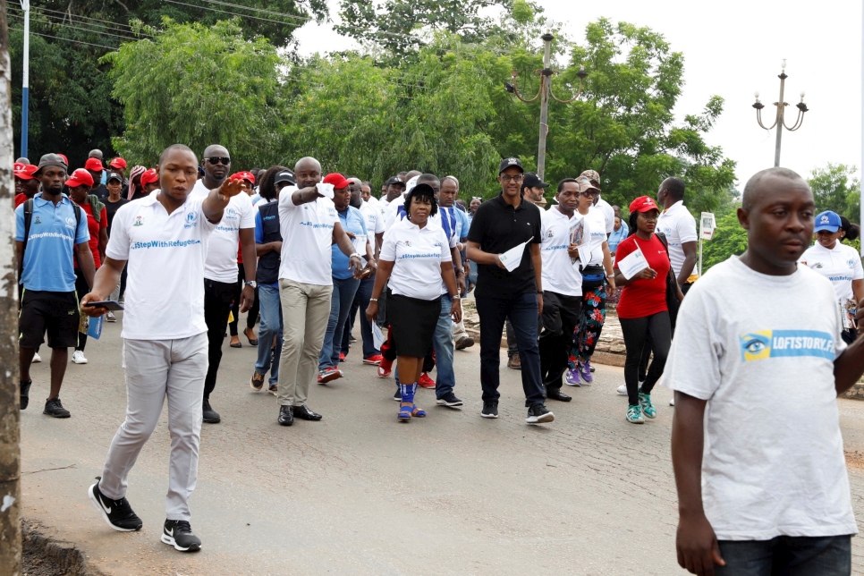 Residents of Ogoja in Nigeria's Cross River State take part in a #StepWithRefugees walk to commemorate World Refugee Day.