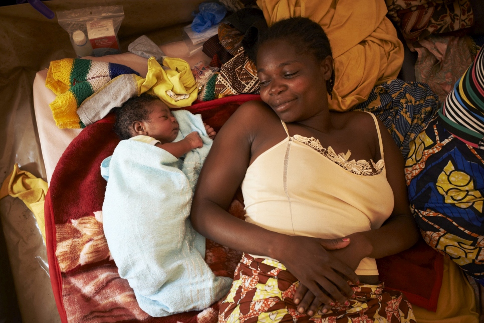 Nailonadege, 35 years old, lies with her baby son Francois Hollande within the maternity ward of the MSF clinic at the international airport in Bangui. Photo credit © UNHCR/Sam Phelps