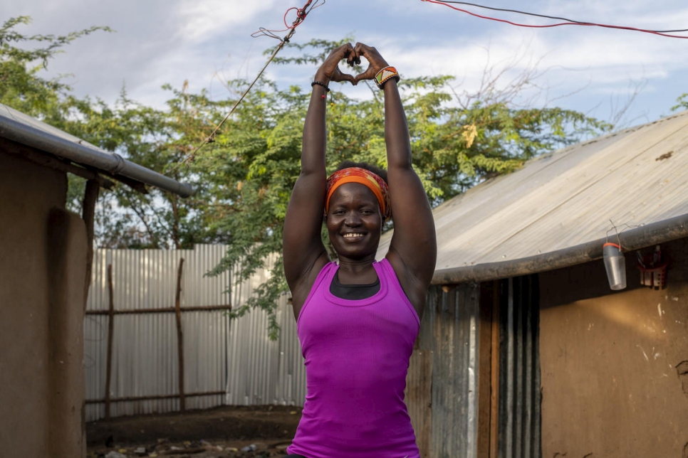 Rita Brown, a Ugandan refugee and yoga instructor, strikes a pose in her compound at Kakuma camp, Kenya. She gives online classes that help refugees and others deal with stress.