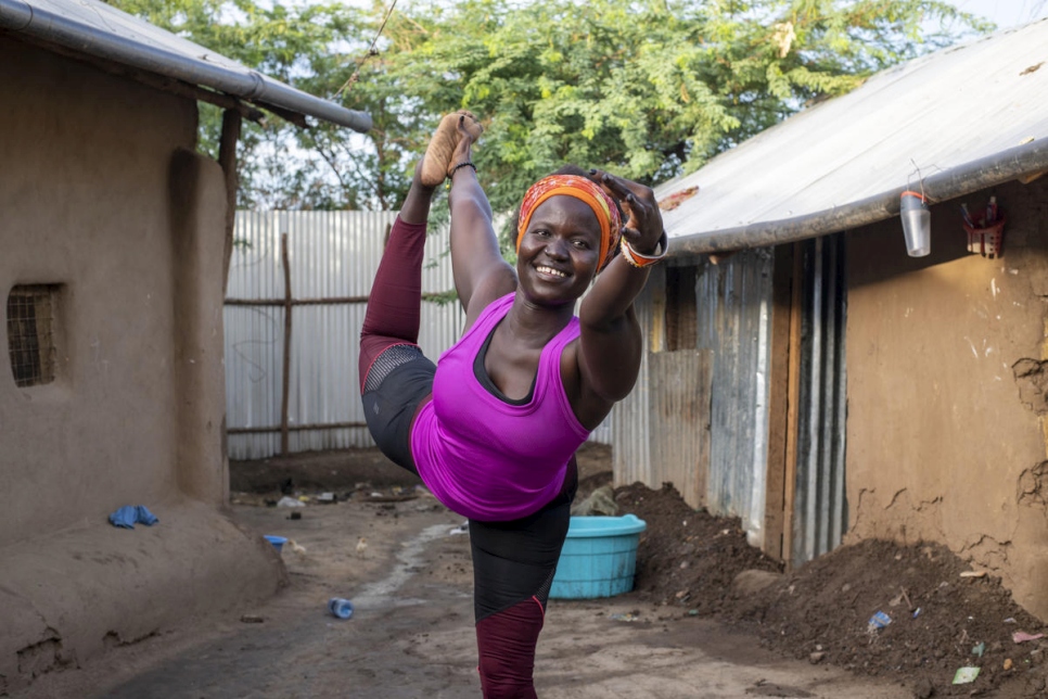 Rita Brown, a Ugandan refugee and yoga instructor, strikes a yoga pose in her compound in Kakuma camp, Kenya.