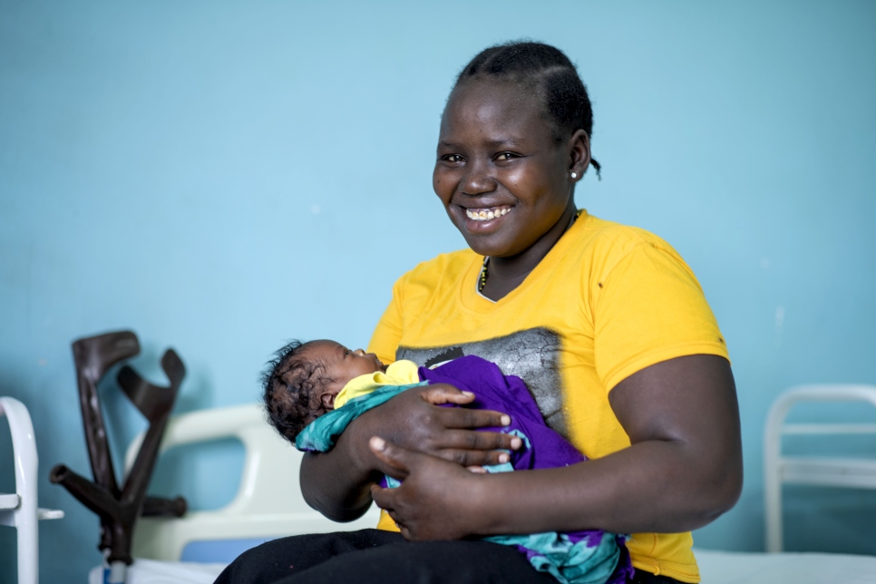 South Sudanese refugee Lucia Amoo, 23, holds her baby boy, Kevin, who was born at Nalemsokon health clinic in Kakuma camp, Kenya, during the pandemic.