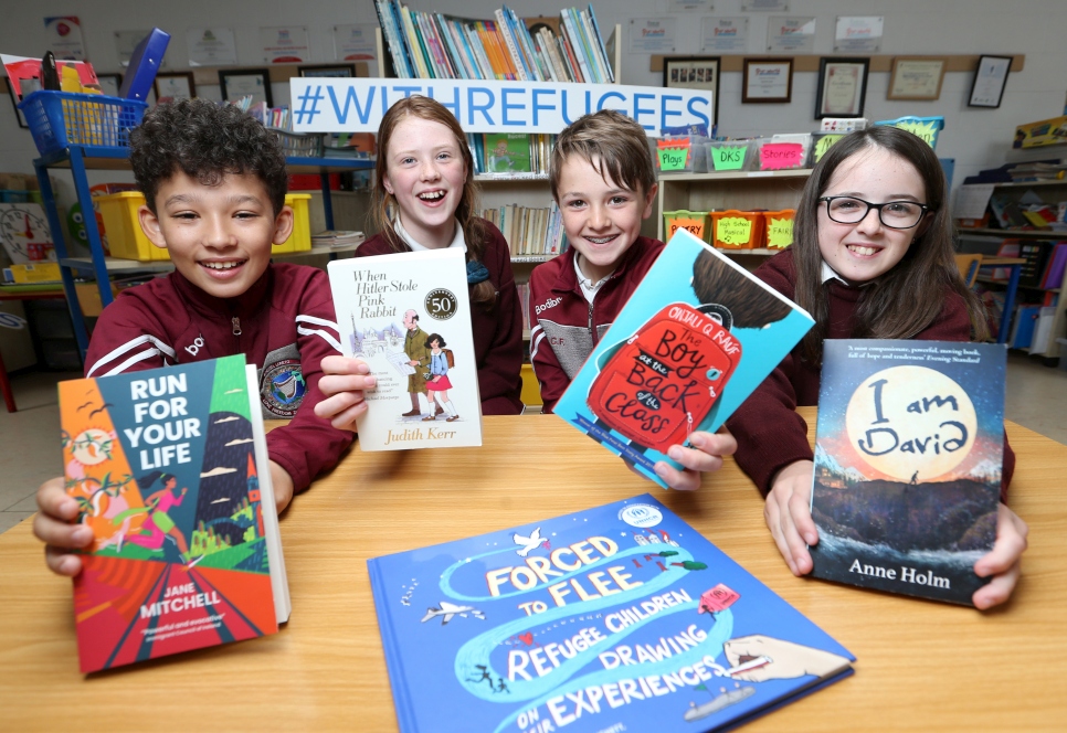 Students from Bunscoil Loreto, Gorey, Co. Wexford, present books from the 2022 Together with Refugees Reading Guide.