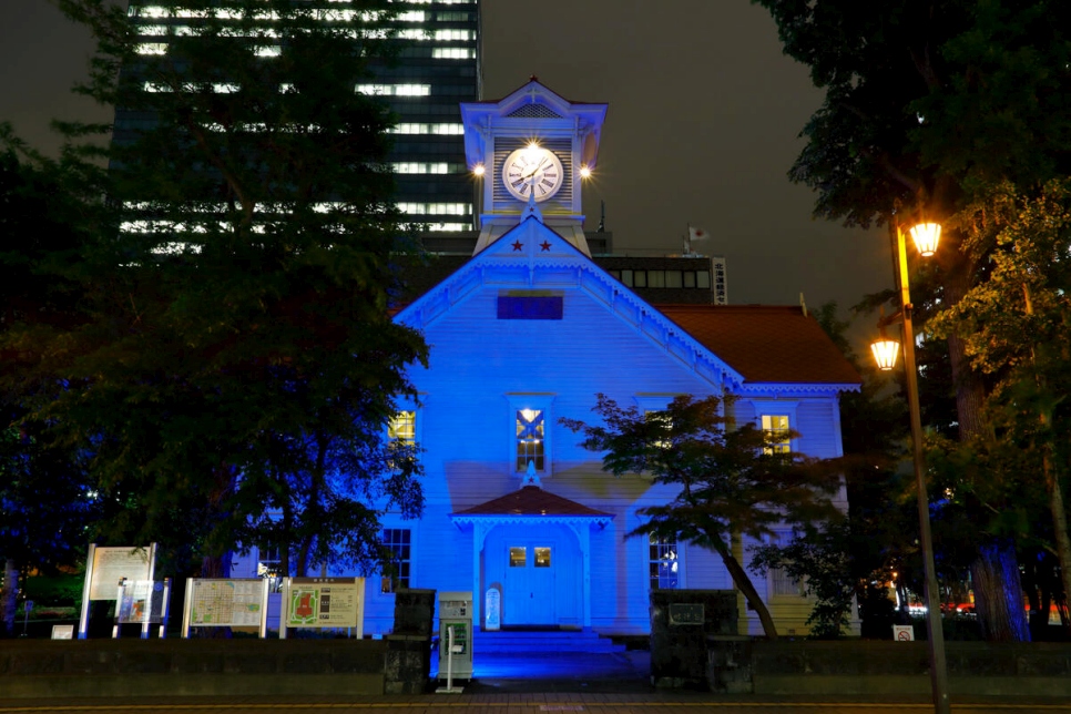 Japan. Sapporo Clock Tower, a historical and cultural symbol of Sapporo City is lit UNHCR Blue on World Refugee Day