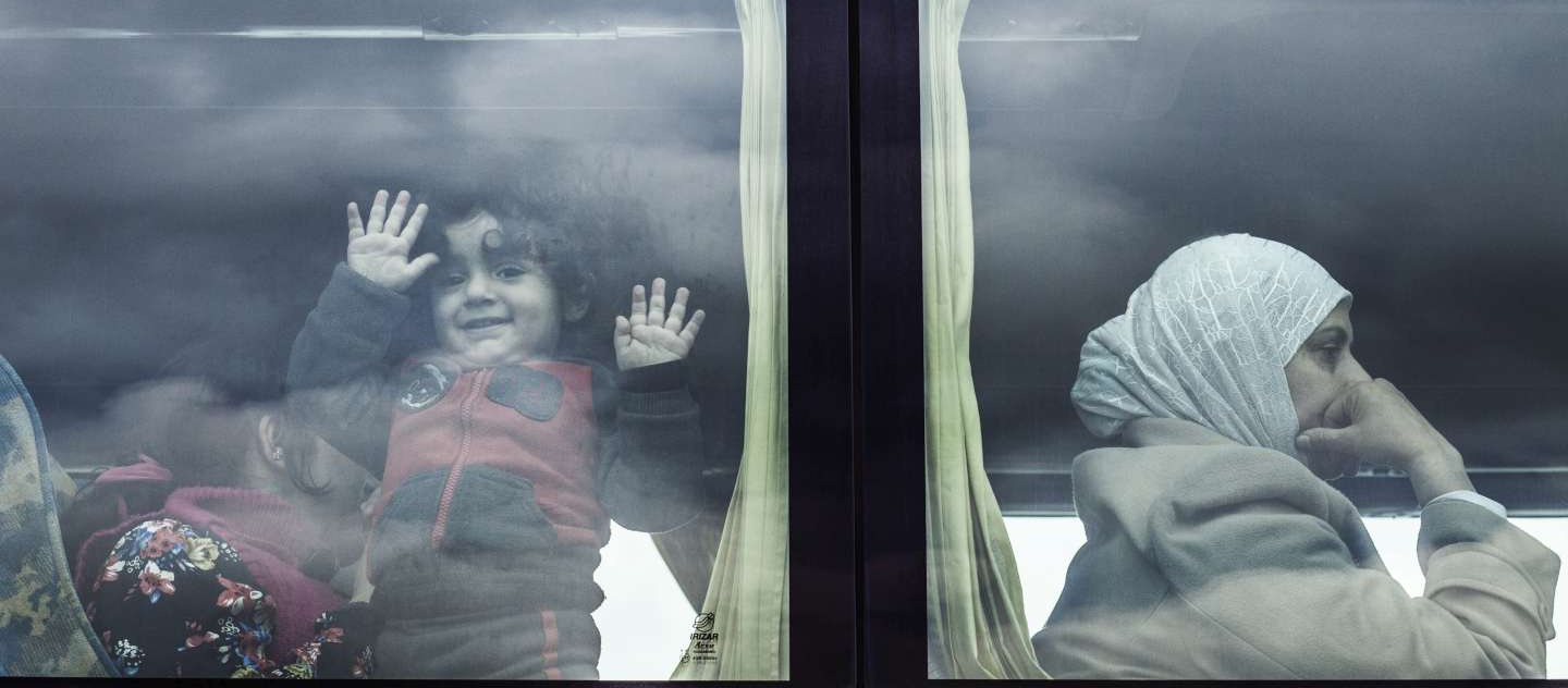 Rescued Syrian refugees are taken from the port of Augusta on Sicily, southern Italy, to a reception centre.