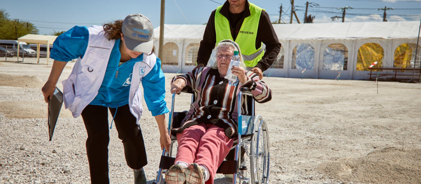 Moldova. Wheelchair-bound woman received by UNHCR at border crossing