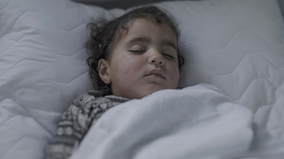 Iman, who fled Syria, has pneumonia and a chest infection. This is her third day in this hospital bed. "She sleeps most of the time now. Normally she's a happy little girl, but now she's tired. She runs everywhere when she's well. She loves playing in the sand," says her mother Olah, 19.