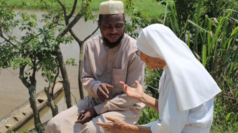 Imam Moustapha Mobito, 36, and Sister Maria, 84, discuss their hopes for a peaceful Democratic Republic of the Congo, on the banks of the Oubangui River.