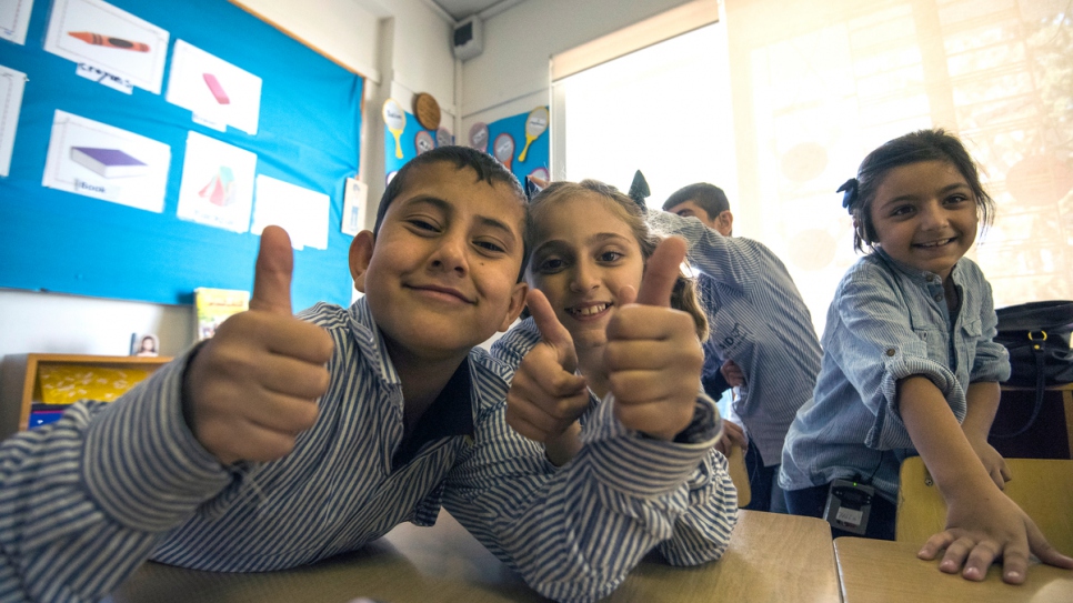 Students give a thumbs up when asked how they feel about their school and teachers.