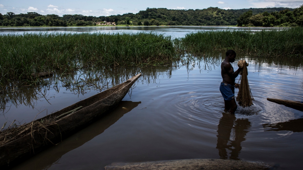 A Central African refugee cleans his fishing net in the village of Satema.