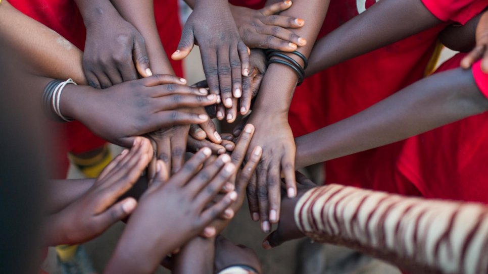 "We are the best team in this camp." Morning Stars team-mates touch hands before a game at Lusenda refugee camp.